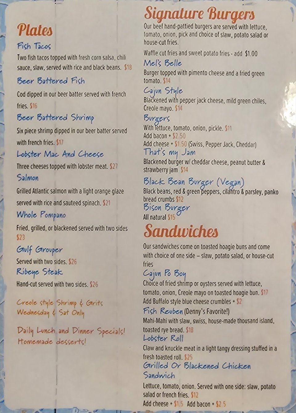 Restaurant menu beside a drink glass.
